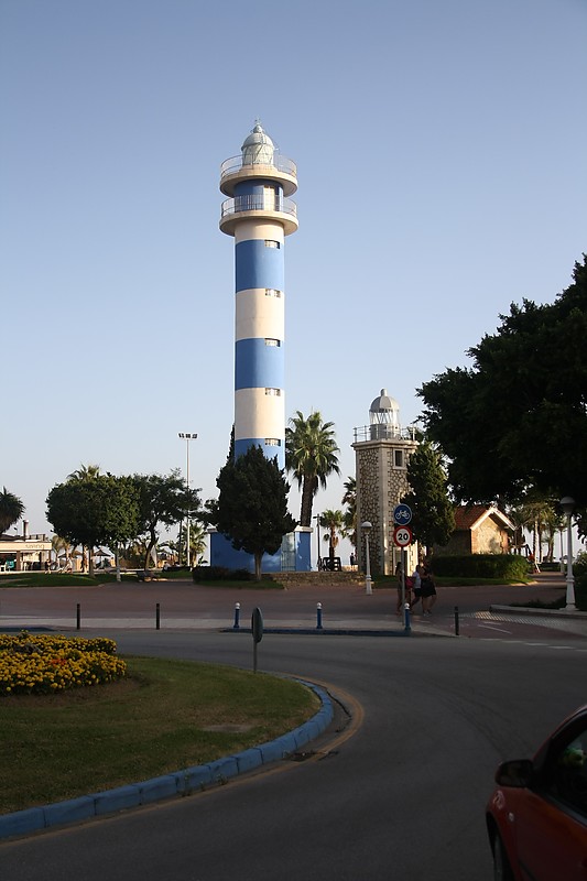 Andalusia / Torre del Mar lighthouses
High - new
Low - old, built 1969 Inactive since 1974, ~10m high tower 
According to Russ Rowlett:
The original lighthouse, built at the mouth of the Río Vélez, collapsed in 1880 due to beach erosion both by the ocean and the river. It was replaced by a "temporary" wood tower, which served until an 11 m (36 ft) masonry replacement tower was finally built in 1930. By the late 1960s, rapid beachfront development had rendered that lighthouse useless, so this tower was built near the ocean beach as a stopgap measure. 
Keywords: Torre del Mar;Spain;Andalusia;Mediterranean sea
